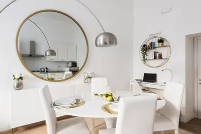 a white dining room with a white table and a mirror at Vatican Imperial Apartment 2840sq ft in Rome