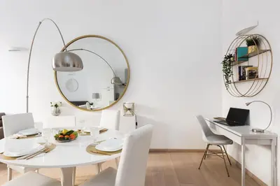 a white dining room with a white table and a mirror at Vatican Imperial Apartment 2840sq ft in Rome