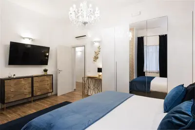 a bedroom with a bed and a television on a wall at Vatican Imperial Apartment 2840sq ft in Rome