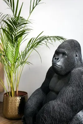 a gorilla statue sitting next to a potted plant at Vatican Imperial Apartment 2840sq ft in Rome