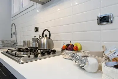 a kitchen counter with a stove and a bowl of fruit at Maison Boncompagni in Rome