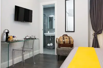 a hotel room with a bed and a table and a chair at Maison Boncompagni in Rome