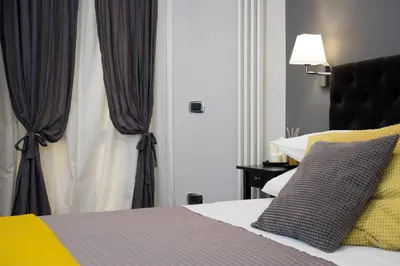 a bedroom with a bed and a window with curtains at Maison Boncompagni in Rome