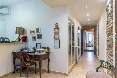 a hallway with a desk and chairs in a house at Camere del Camerlengo in Rome
