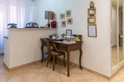 a desk with a chair next to a wall at Camere del Camerlengo in Rome