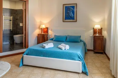 a bedroom with a blue bed with towels on it at Camere del Camerlengo in Rome