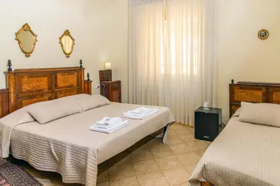 a bedroom with two beds with towels on them at Camere del Camerlengo in Rome