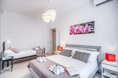 a bedroom with two beds in a room at Vaticanum Modern & Family Apartment in Rome