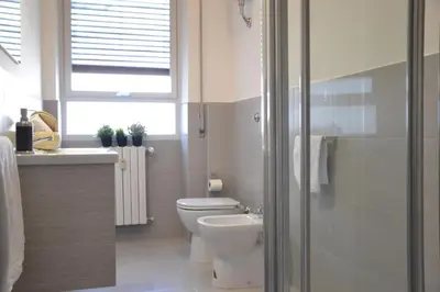 a bathroom with a toilet and a sink and a shower at Vaticanum Modern & Family Apartment in Rome