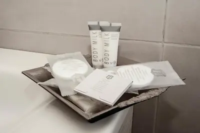 a shelf with products on top of a bathroom counter at Vaticanum Modern & Family Apartment in Rome
