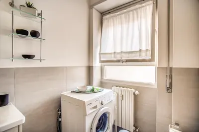 a laundry room with a washer and a window at Vaticanum Modern & Family Apartment in Rome