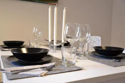 a table with black bowls and glasses on it at Vaticanum Modern & Family Apartment in Rome