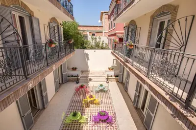 an apartment balcony with tables and chairs on it at The Bricks Rome in Rome