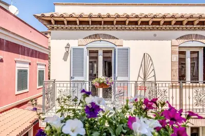 a house with flowers on a balcony at The Bricks Rome in Rome