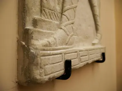 a stone artifact hanging on a wall at Hotel 4 Coronati in Rome