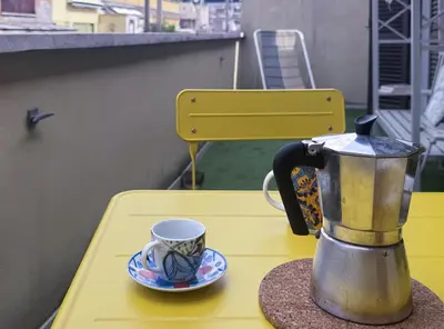 a coffee maker and a cup on a table at Vatican Attic With Terrace in Rome