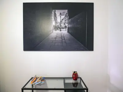 a picture hanging on a wall with a glass table at Vatican Attic With Terrace in Rome