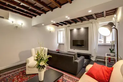 a living room with a couch and a tv at Campo de' Fiori Stylish White in Rome