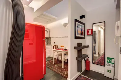a red refrigerator in a room with a table at Campo de' Fiori Stylish White in Rome