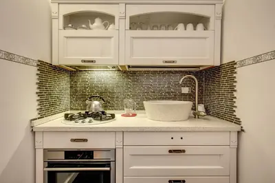 a kitchen with white cabinets and a sink at Campo de' Fiori Stylish White in Rome