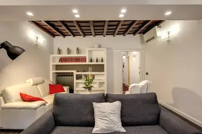 a living room with a couch and a chair at Campo de' Fiori Stylish White in Rome