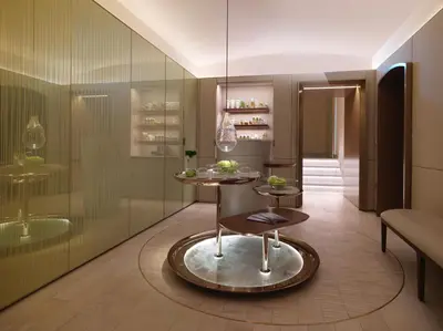 a room with a table and a glass wall at Hotel Eden - Dorchester Collection in Rome