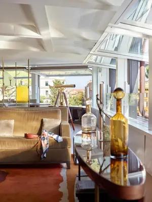 a living room with a couch and a table at Hotel Eden - Dorchester Collection in Rome
