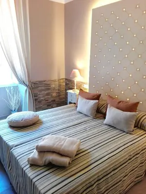 a bedroom with a large bed with two pillows on it at Aleardo Aleardi in Rome