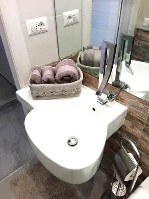 a bathroom with a white toilet and a sink at Aleardo Aleardi in Rome