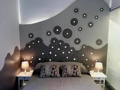 a bedroom with a bed with a bunch of records on the wall at Aleardo Aleardi in Rome