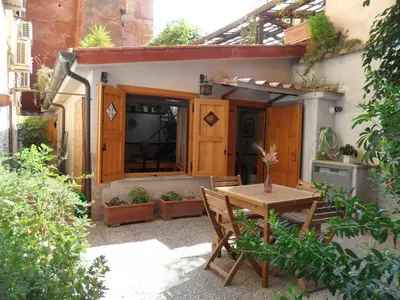 a patio with a table and chairs in front of a house at Colosseum Cottage in Rome