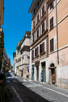 an empty street in a city with buildings at Colosseum Cottage in Rome