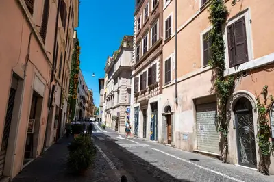 an empty street in an alley with buildings at Colosseum Cottage in Rome