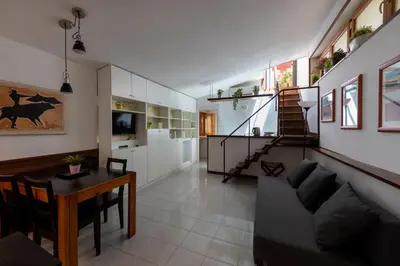 a living room with a couch and a table at Colosseum Cottage in Rome