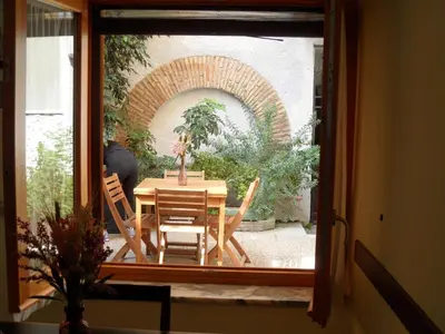 a view of a table and chairs through a window at Colosseum Cottage in Rome