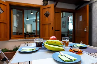 a table with a bunch of bananas and fruit on it at Colosseum Cottage in Rome
