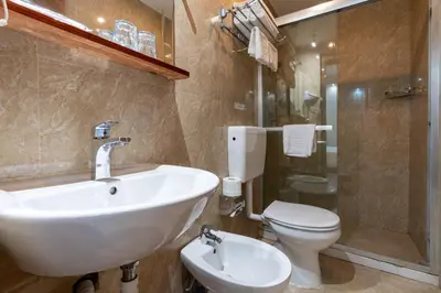 a bathroom with a sink and a toilet and a shower at Leone D'Oro GUESTHOUSE - close to Piazza Vittorio in Rome