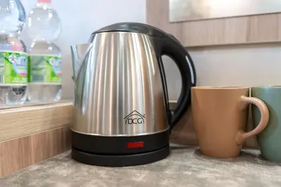 a tea kettle on a counter next to a coffee mug at Leone D'Oro GUESTHOUSE - close to Piazza Vittorio in Rome