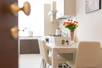a kitchen with a table with a vase of flowers on it at Residenza Monteverde in Rome