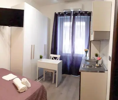a room with a bed and a table and a window at Residenza Monteverde in Rome