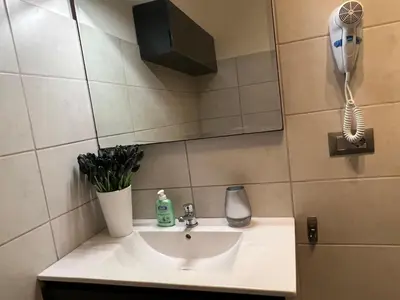 a bathroom sink with a hair dryer and a phone at Residenza Monteverde in Rome