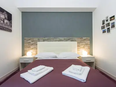 a bedroom with a bed with two towels on it at Guesthouse Park Pines in Rome