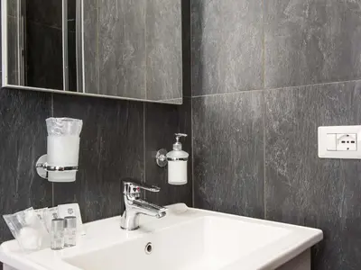 a bathroom with a sink and a mirror at Guesthouse Park Pines in Rome