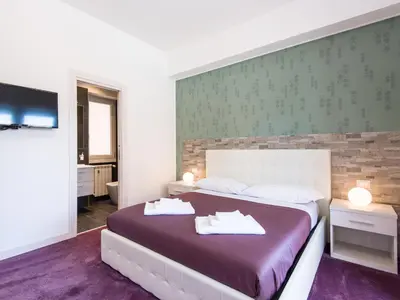 a bedroom with a bed with two white towels on it at Guesthouse Park Pines in Rome