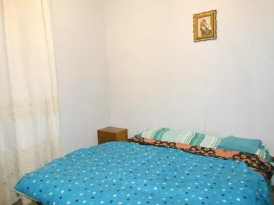 a bedroom with a bed with a blue comforter at Casa di Roma in Rome