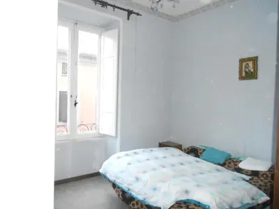 a bedroom with a bed and a window at Casa di Roma in Rome