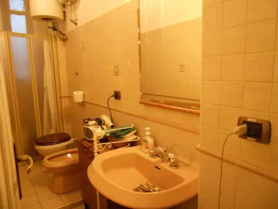 a bathroom with a sink and a toilet at Casa di Roma in Rome