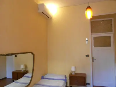 a room with two beds and a mirror at Casa di Roma in Rome