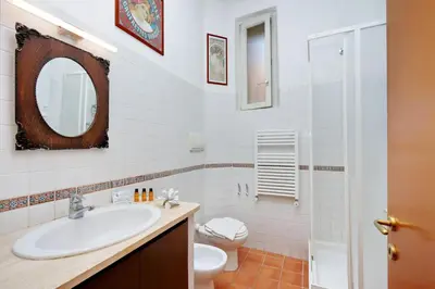 a white bathroom with a sink and a toilet at Romalibera in Rome