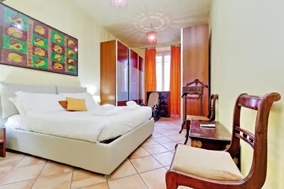 a bedroom with a bed and a desk and a chair at Romalibera in Rome